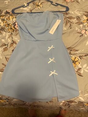 Timing Light Blue Strapless Mini Dress with White Bow Details. Built in shorts.